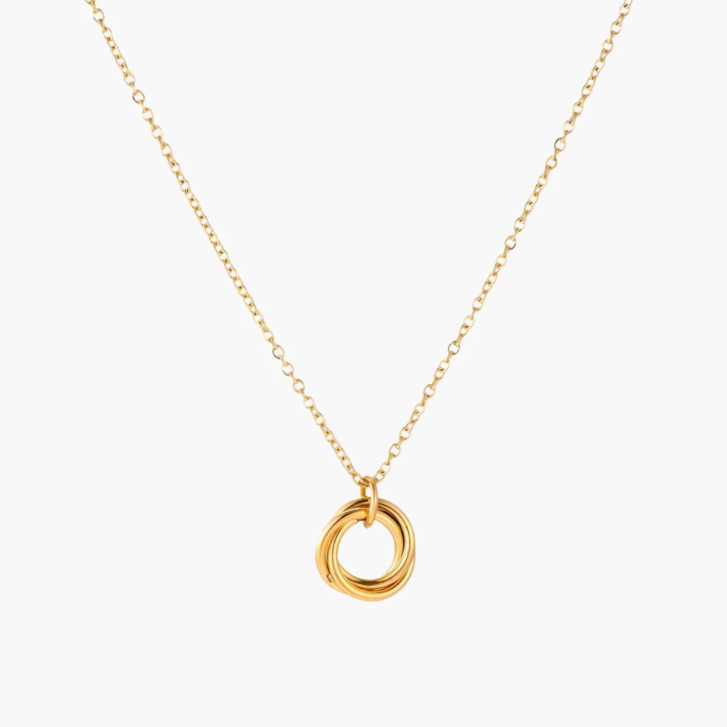 Delicate gold-plated necklace with three interlocking circle rings forming a minimalist knot pendant on cream background