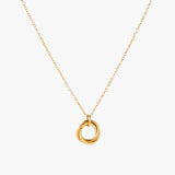 Delicate gold-plated necklace with three interlocking circle rings forming a minimalist knot pendant on cream background