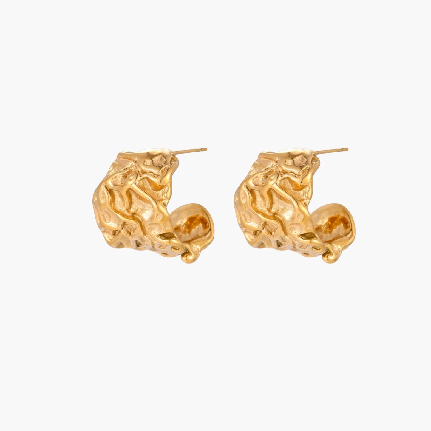 Sculptural gold-plated hoops with organic crushed texture on cream background