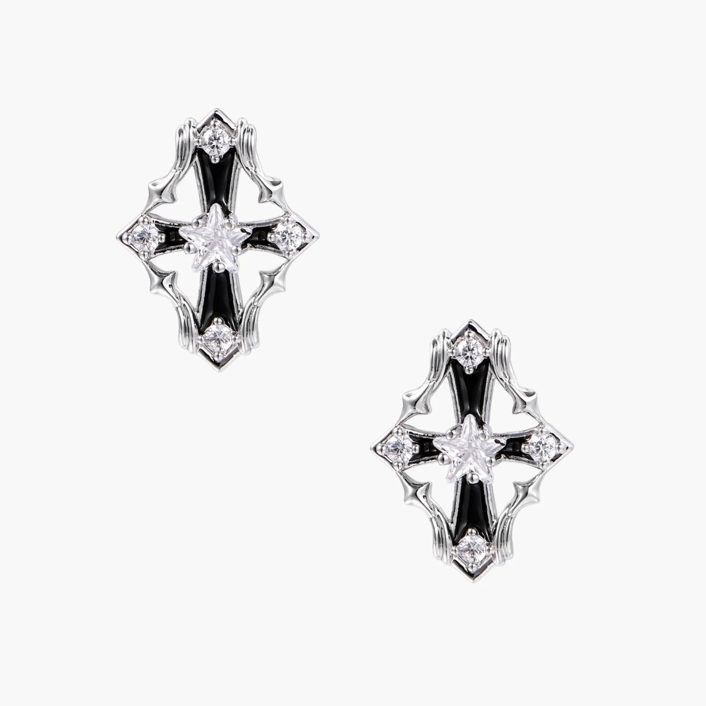 Pair of Art Deco-style stud earrings with star crystals, black enamel accents, and white gold plating on ivory background.