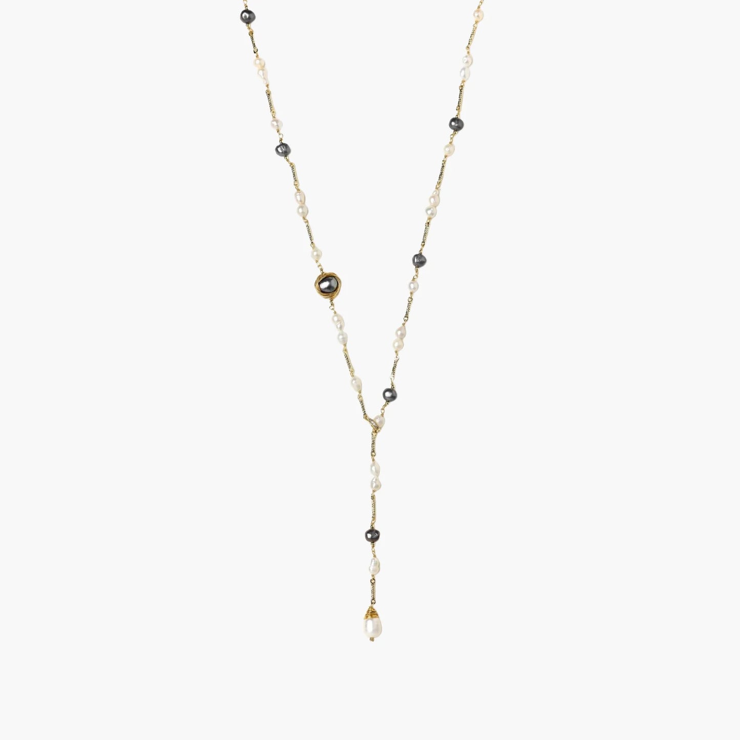 Y-shaped gold-plated necklace with white and gray freshwater pearls on cream background, showing adjustable drop design.