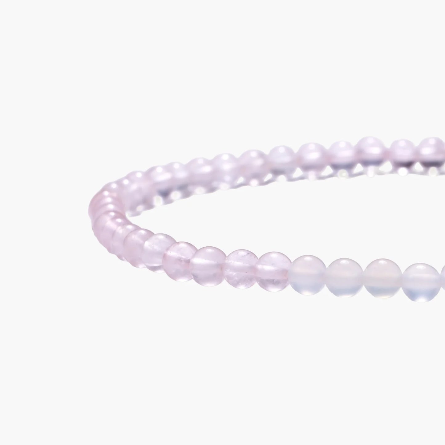 Double-wrap lavender beaded bracelet with rose quartz, pearls, gold vermeil charm and pink tassel on white background.