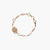 Gold-plated bracelet with pink baroque pearl centerpiece, floral connector, and freshwater pearls