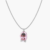 Translucent pink skull pendant with silver bow detail on delicate white gold plated chain against cream background