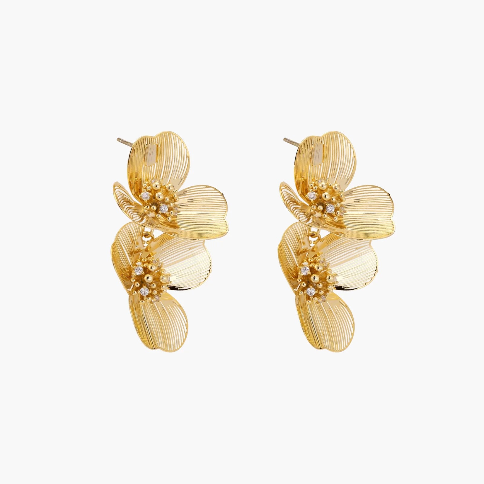 Pair of gold-plated double flower earrings with textured petals and crystal centers on cream background.