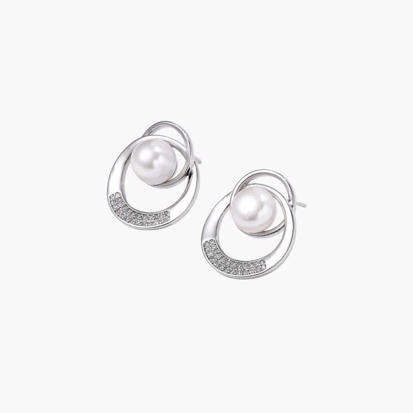 White gold-plated brass earrings with circular design, freshwater pearl center, and diamond accents