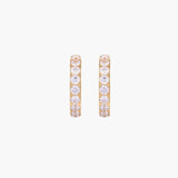 Gold pavé hoop earrings with two freshwater pearls nestled inside the curved design, featuring crystal-studded outer edge.