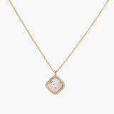 Gold quatrefoil pendant with crystal center on iridescent mother-of-pearl base, adjustable gold chain on cream background