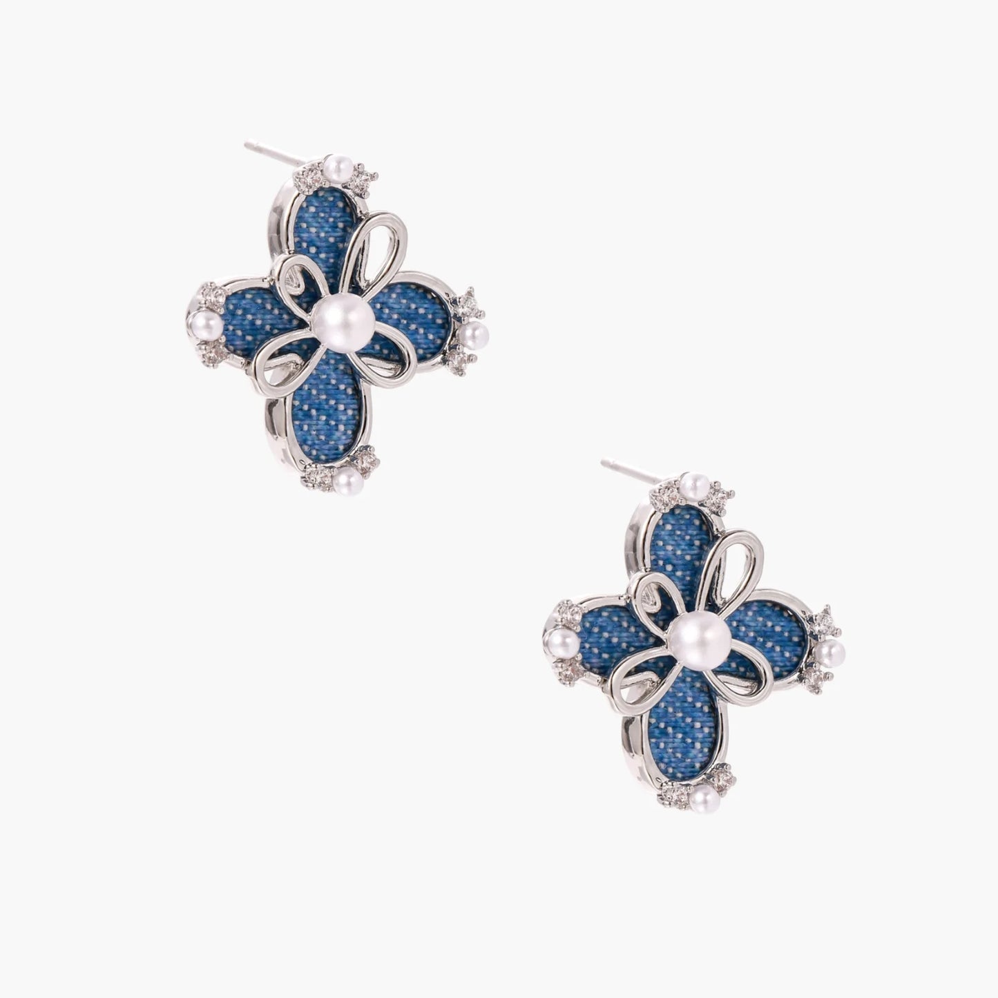 Blue denim fabric flower studs with white gold plated petals, pearl center, and zirconia accents on white background