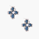 Blue denim fabric flower studs with white gold plated petals, pearl center, and zirconia accents on white background