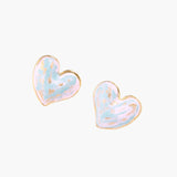 Heart-shaped stud earrings with swirled turquoise and pink enamel in gold-plated frames on cream background