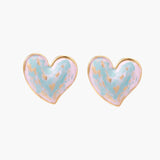 Heart-shaped stud earrings with swirled turquoise and pink enamel in gold-plated frames on cream background