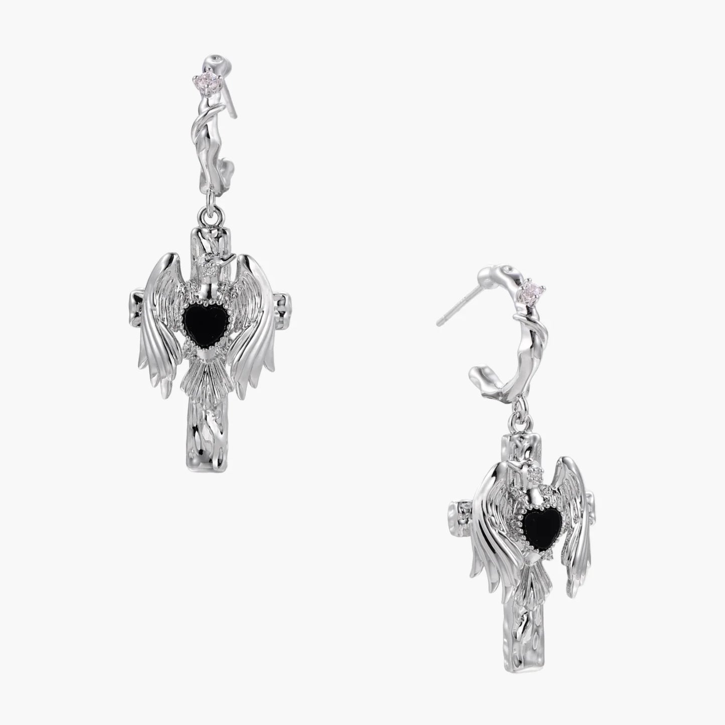 Silver drop earrings with twisted hoops and angel wings embracing black heart locket on white background.