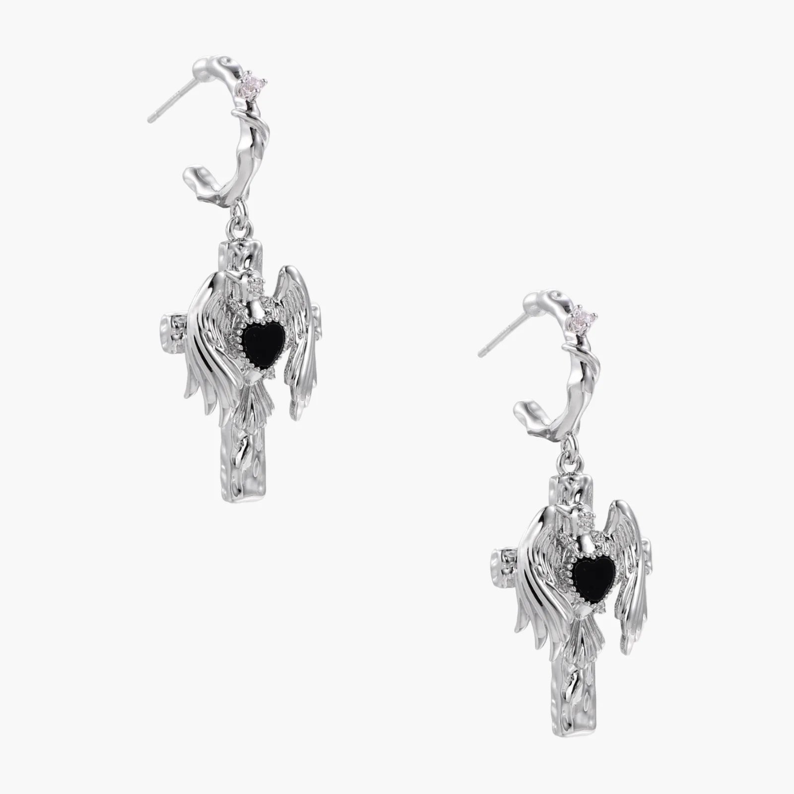 Silver drop earrings with twisted hoops and angel wings embracing black heart locket on white background.