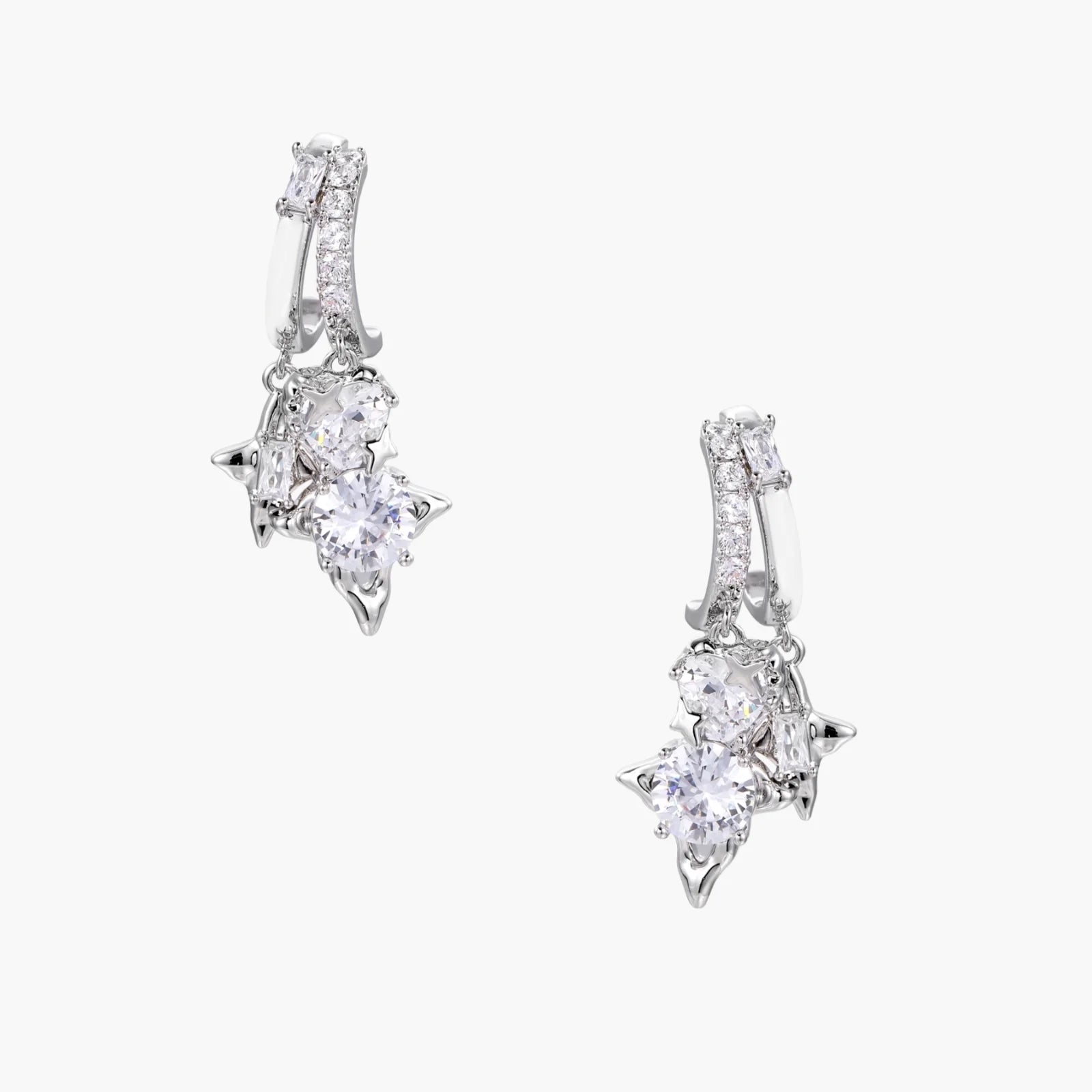 White gold-plated huggie earrings with geometric emerald-cut zirconia clusters in starburst formation on beige background