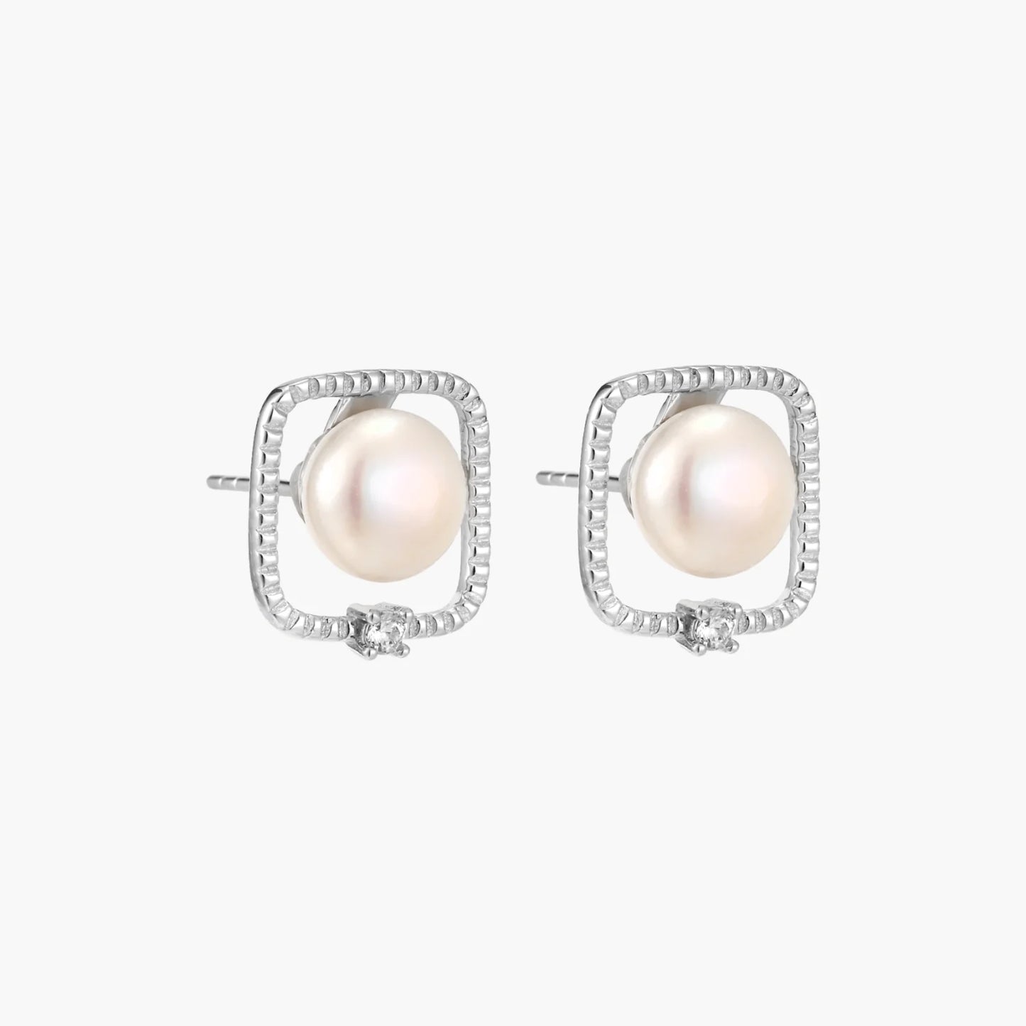 Rhodium-plated silver stud earrings with cushion frame, centered freshwater pearl, and tiny crystal accent