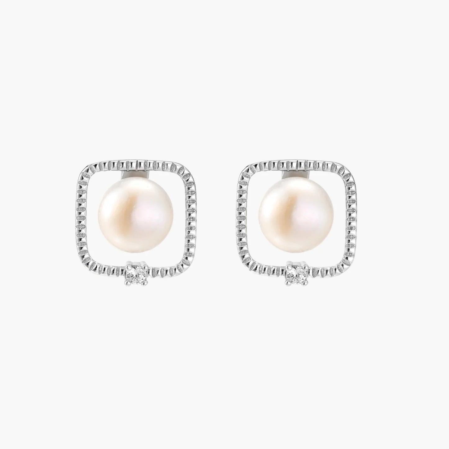 Rhodium-plated silver stud earrings with cushion frame, centered freshwater pearl, and tiny crystal accent
