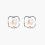 Rhodium-plated silver stud earrings with cushion frame, centered freshwater pearl, and tiny crystal accent