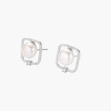 Rhodium-plated silver stud earrings with cushion frame, centered freshwater pearl, and tiny crystal accent
