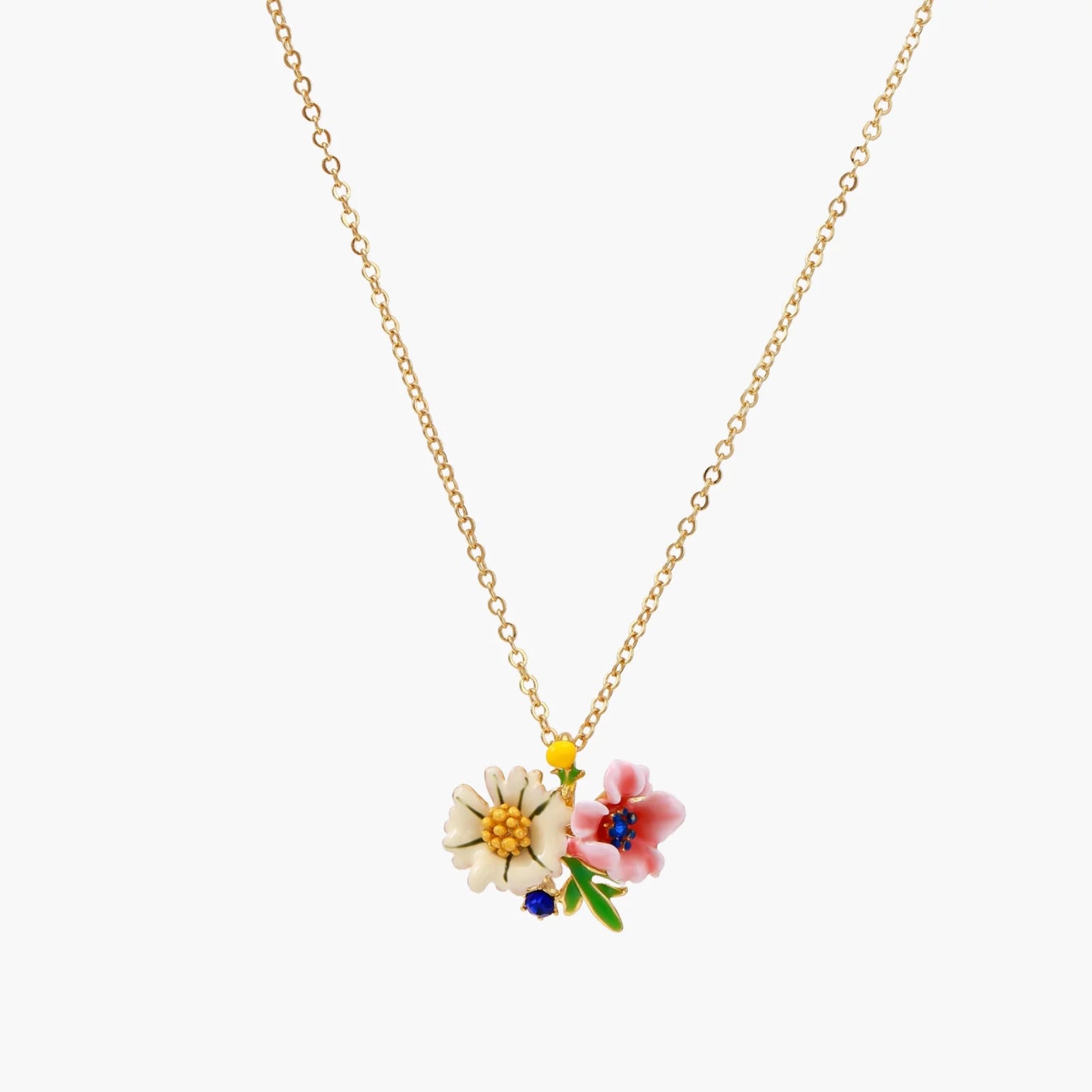 Enamel floral pendant necklace with white daisy, pink flower, yellow and blue accents on gold chain against cream background.