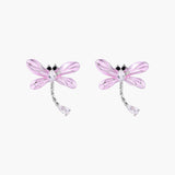 Long drop earrings with translucent lavender enamel dragonfly wings and white gold plated segmented bodies on white background
