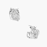 Close-up of sculptural hoop earrings with lattice center band and smooth twisted edges in white gold-plated brass with zirconia