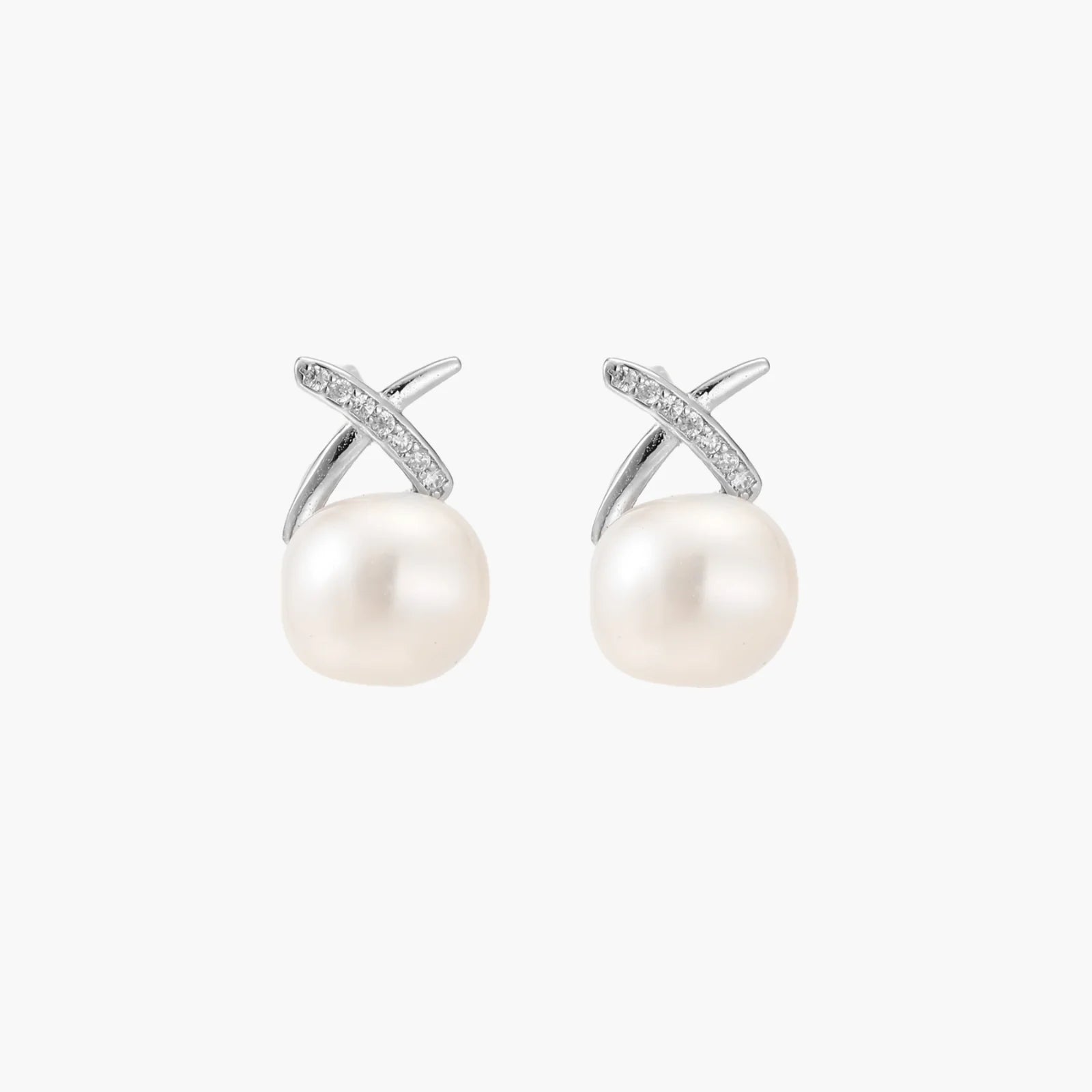 Rhodium-plated silver stud earrings with sparkling X design above lustrous round freshwater pearls on white background.