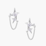Silver star studs with crescent moon cutouts and zirconia stones connected by delicate chains on white background