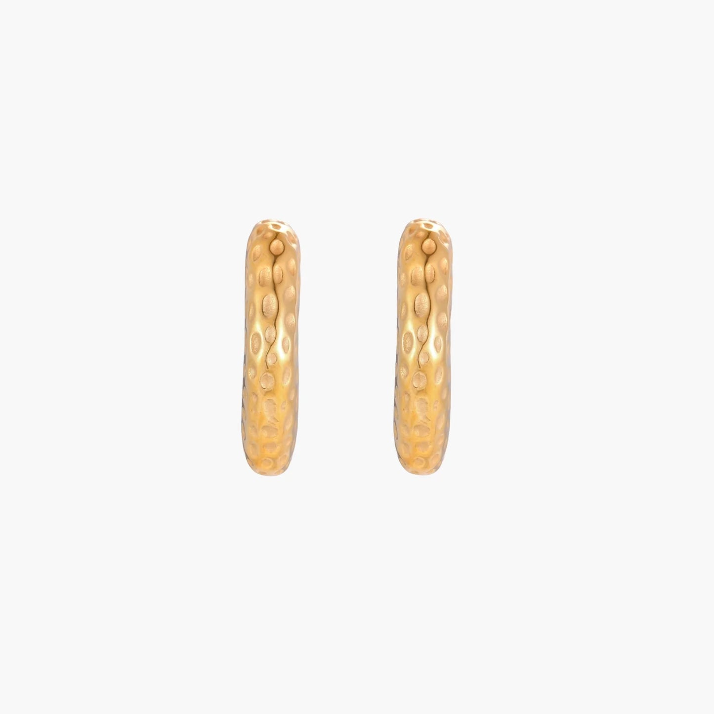 Gold-toned hoop earrings with hammered dimpled texture and post closure on cream background