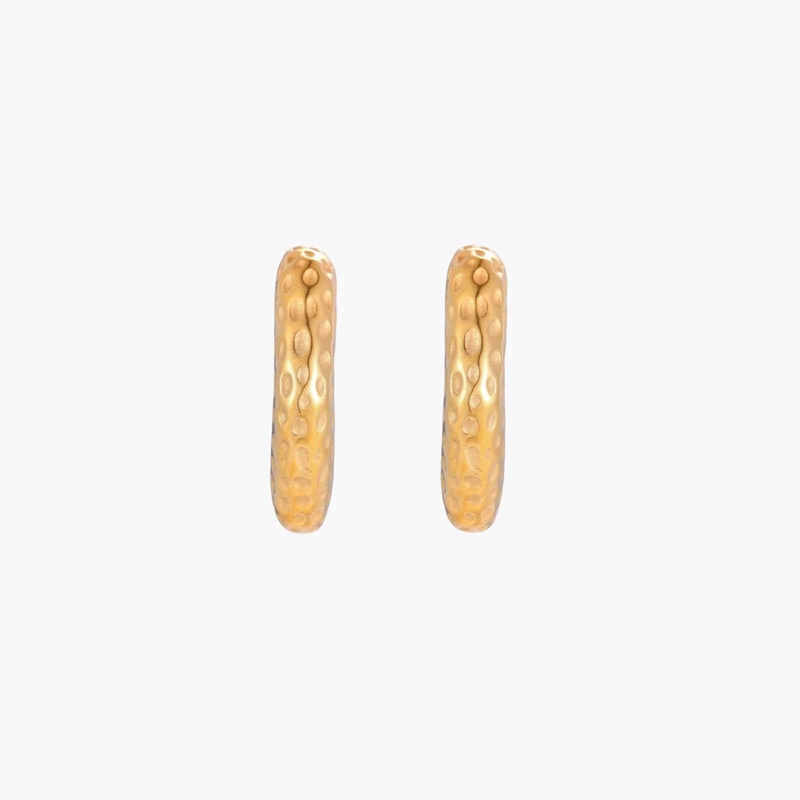 Gold-toned hoop earrings with hammered dimpled texture and post closure on cream background