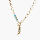 Gold chunky chain necklace with turquoise beaded accent and horn pendant on white background