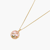 Gold pendant with pink enamel backdrop, white freshwater pearls as tulip blooms, and green leaf accents on rope chain.