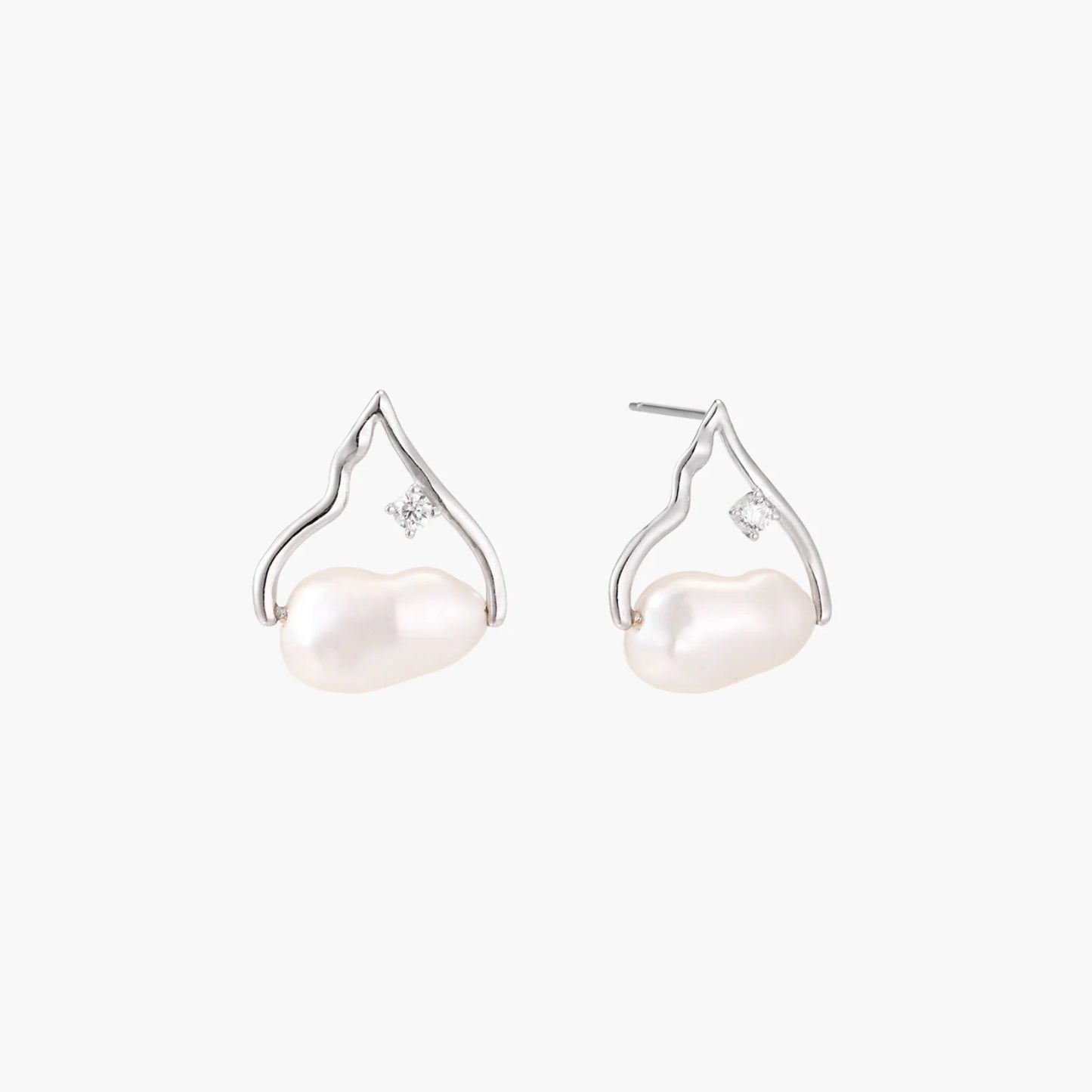 Silver mountain outline studs with baroque pearl and diamond accent on white background