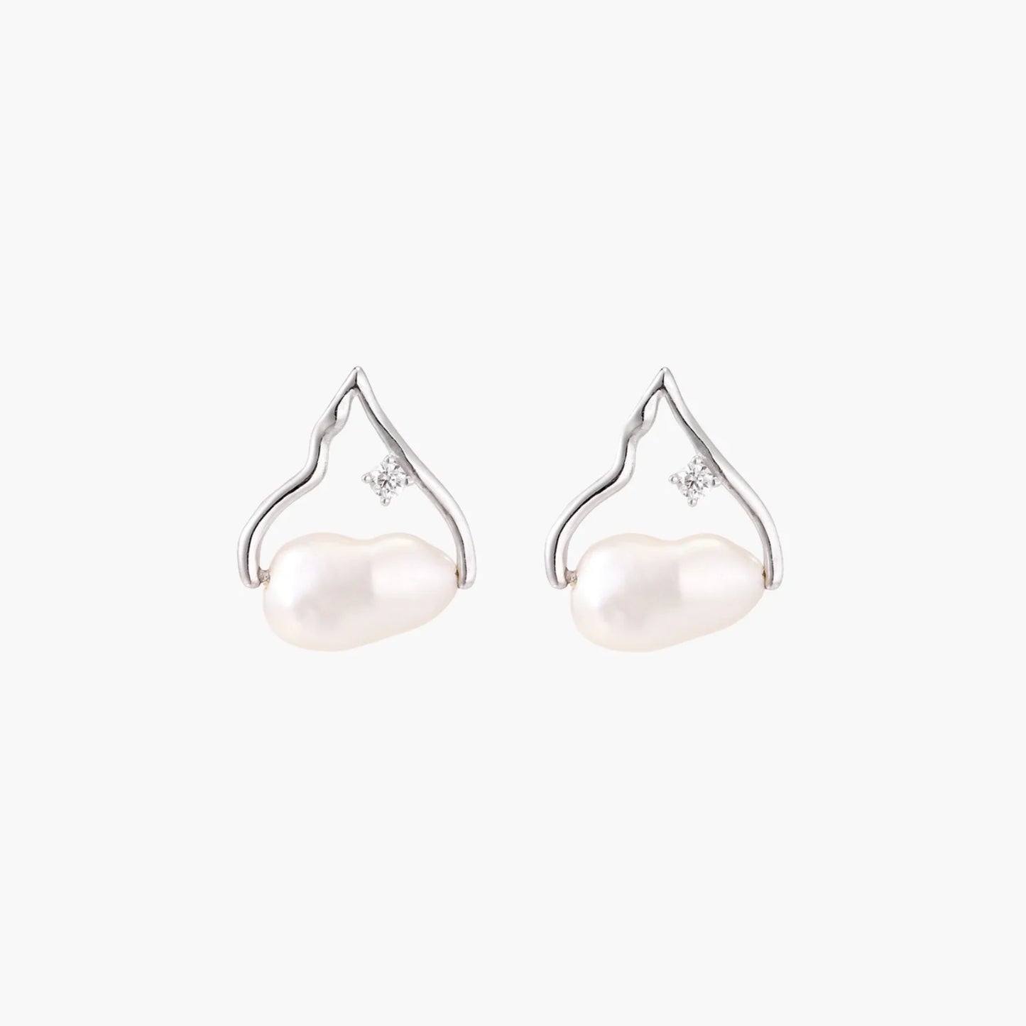 Silver mountain outline studs with baroque pearl and diamond accent on white background