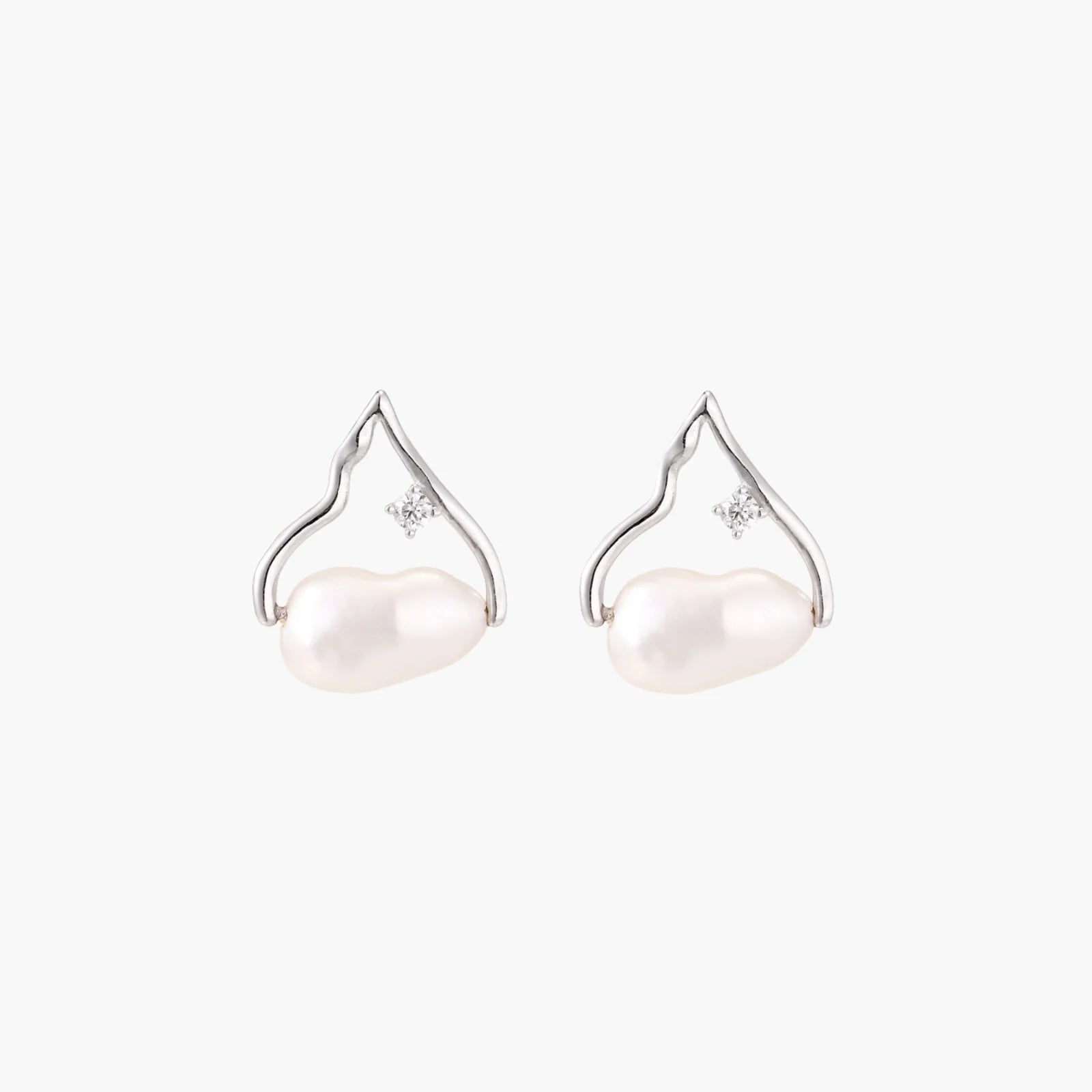 Silver mountain outline studs with baroque pearl and diamond accent on white background