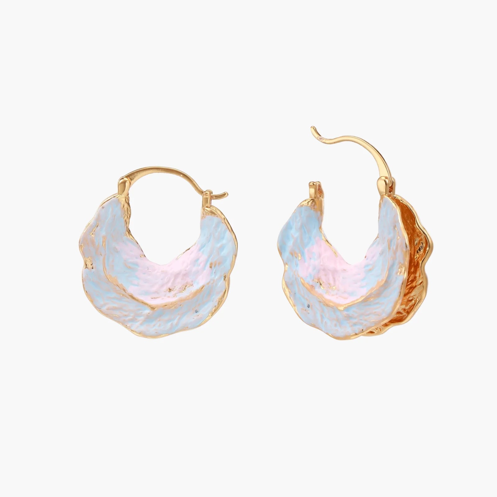 Shell-shaped hoop earrings with iridescent blue-pink enamel and gold trim on cream background