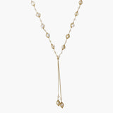 Adjustable gold lariat necklace with freshwater pearls nested in delicate cage settings and Y-shaped tassel drop