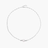 Dainty rhodium-plated silver chain necklace with centered 10mm freshwater pearl and crystal accents on cream background