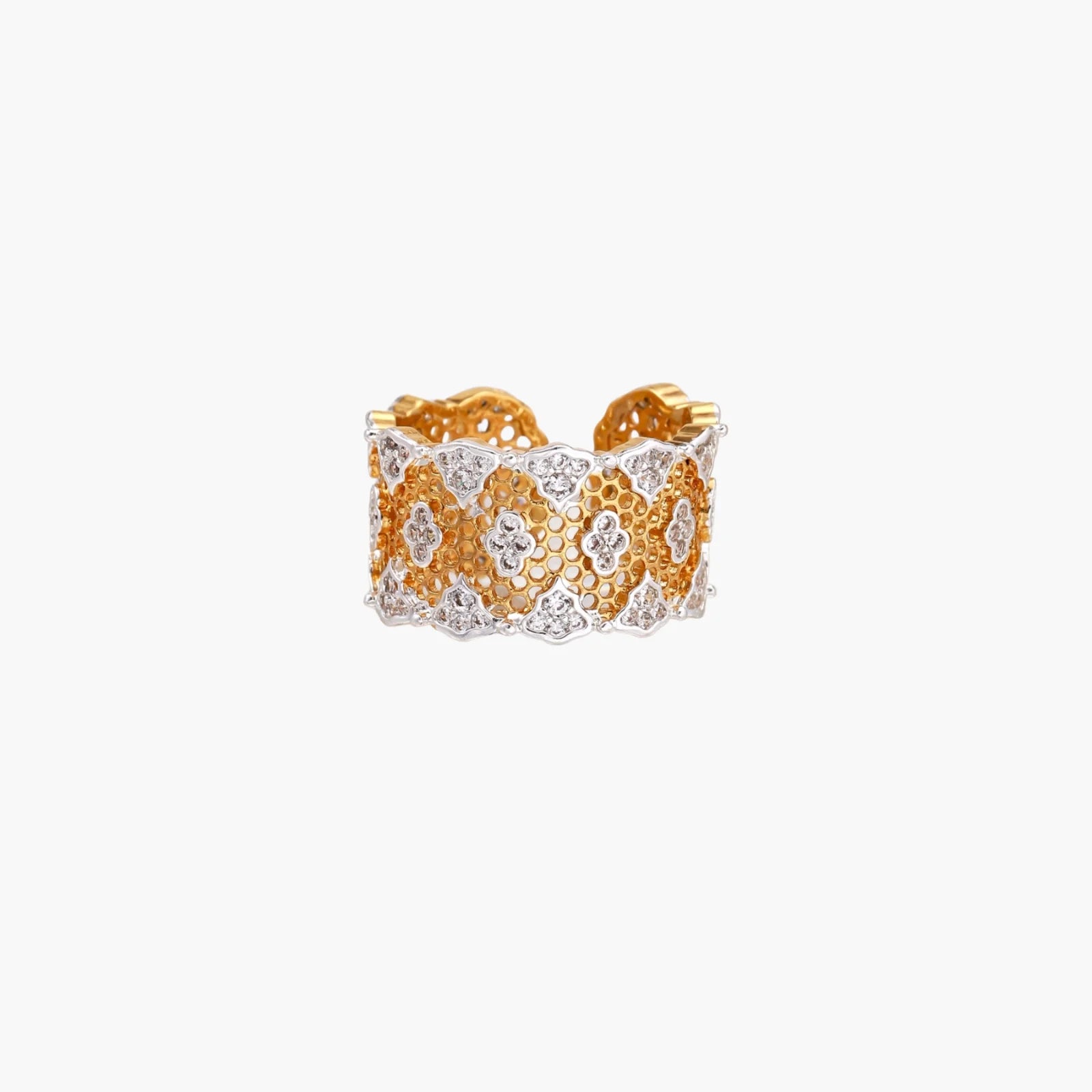Two-tone gold and silver lattice ring with clover pattern and crystal accents on white background