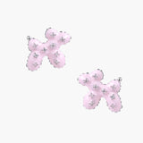 Glossy pink enamel balloon dog stud earrings with crystal details on white gold plated brass, museum-inspired design