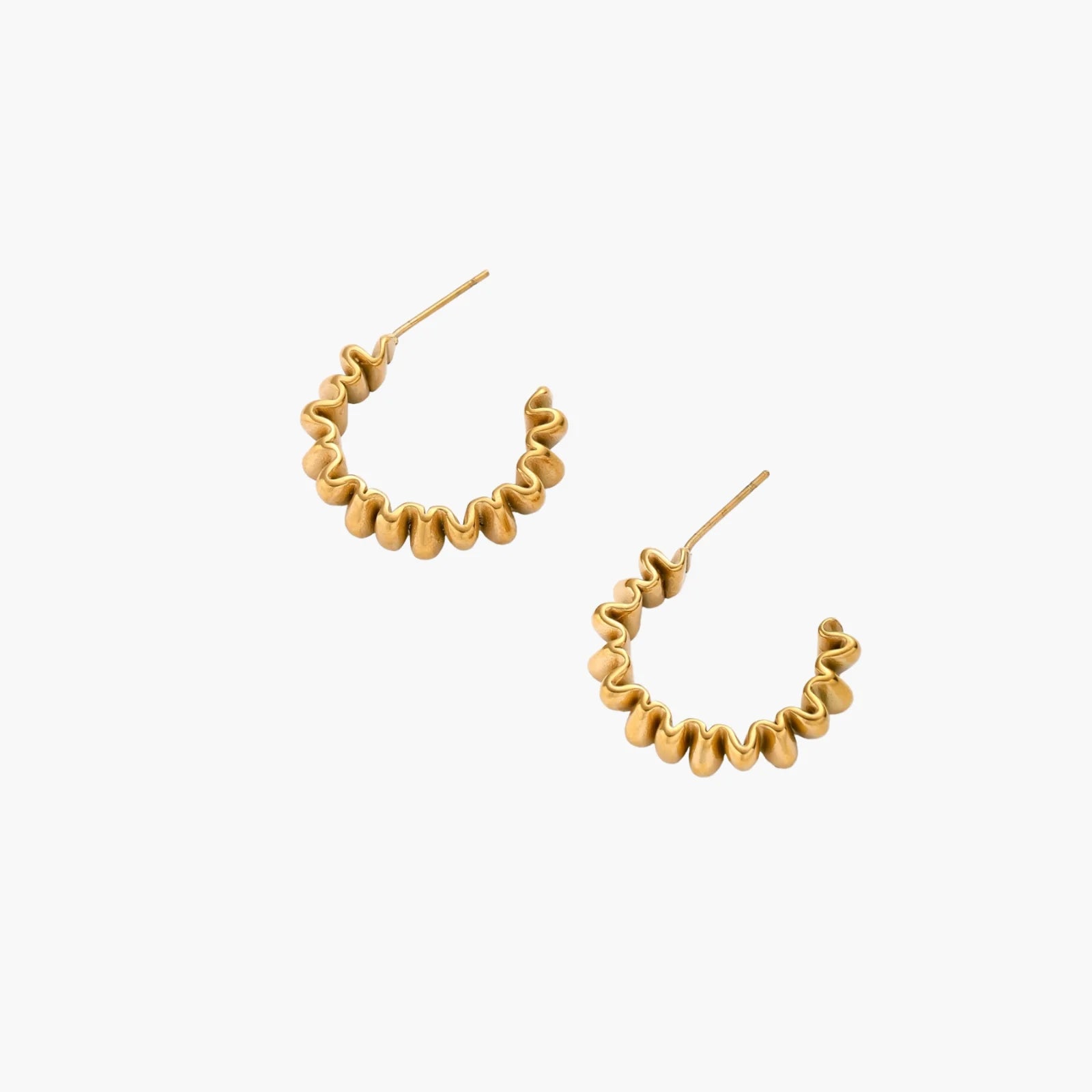 Sculptural gold-plated hoop earrings with continuous twisted spiral design on cream background