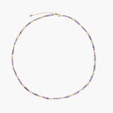 Delicate 18K gold vermeil necklace with alternating lavender zirconia beads and white freshwater pearls on cream background