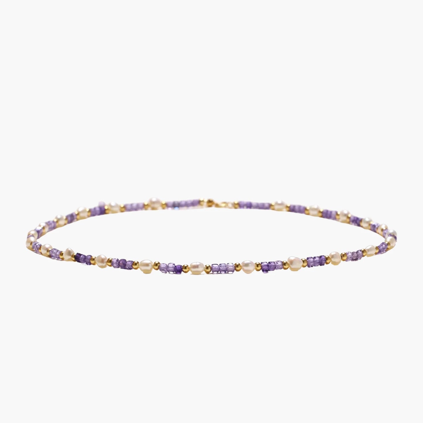 Delicate 18K gold vermeil necklace with alternating lavender zirconia beads and white freshwater pearls on cream background