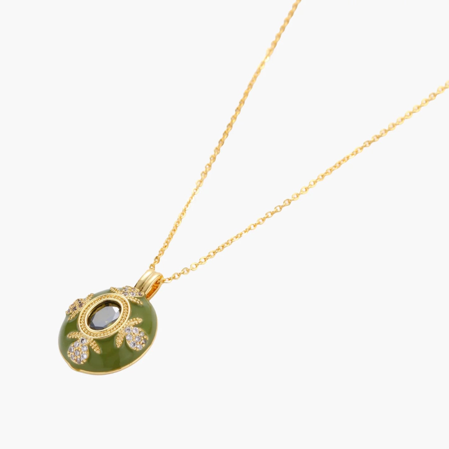 Gold-plated pendant necklace with green enamel background and oval olive cubic zirconia center stone with crystal accents.